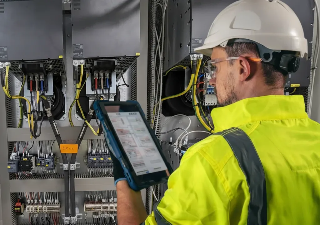 Technician inspecting a control cabinet